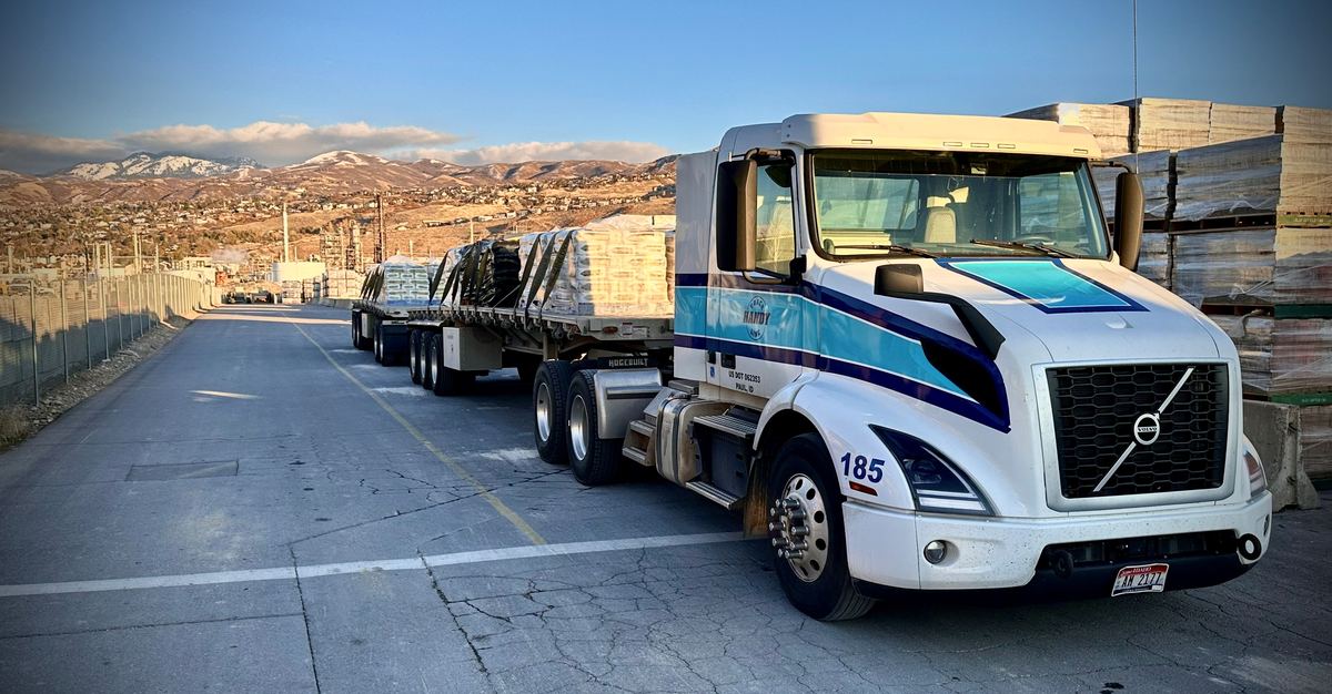 Flatbed truck loaded with palletized building materials