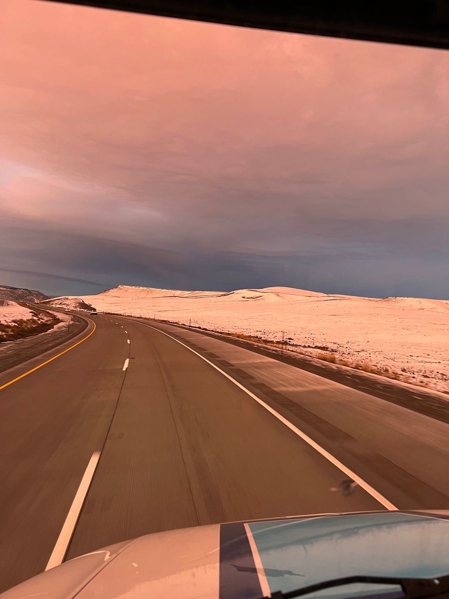 View of the open road from a Handy Truck Line cab at dawn